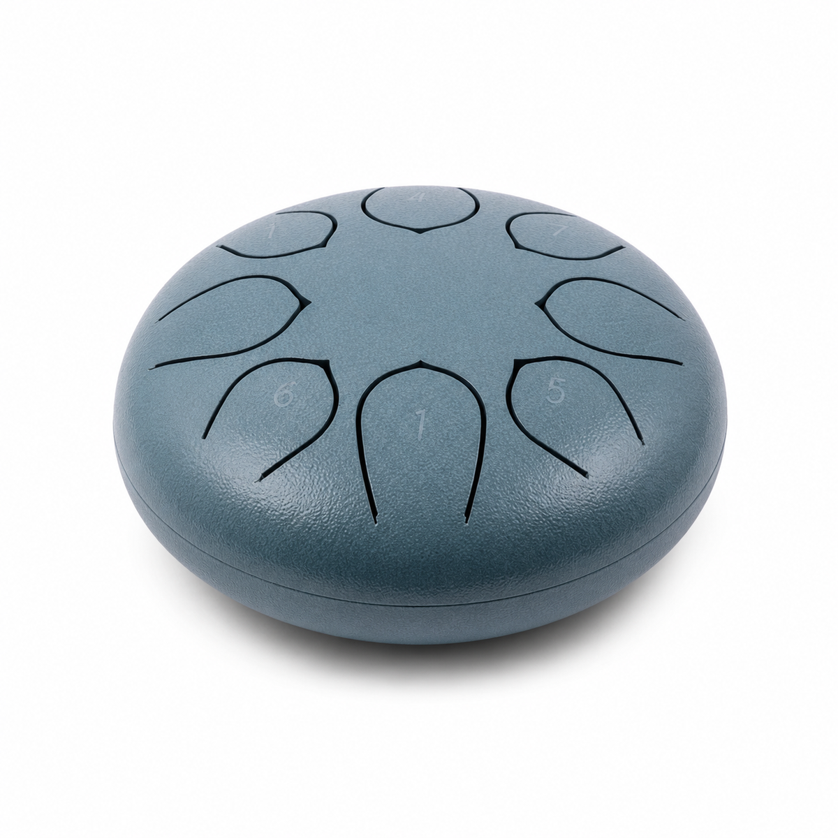 Tongue drum en acier posé sur une table basse